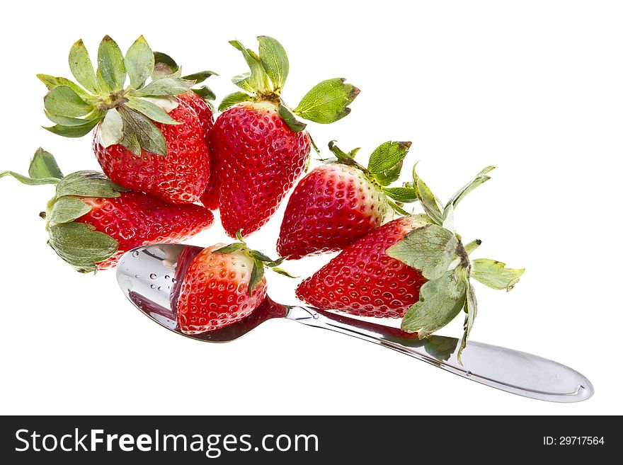 Tasty strawberries with a metal spoon isolated on white