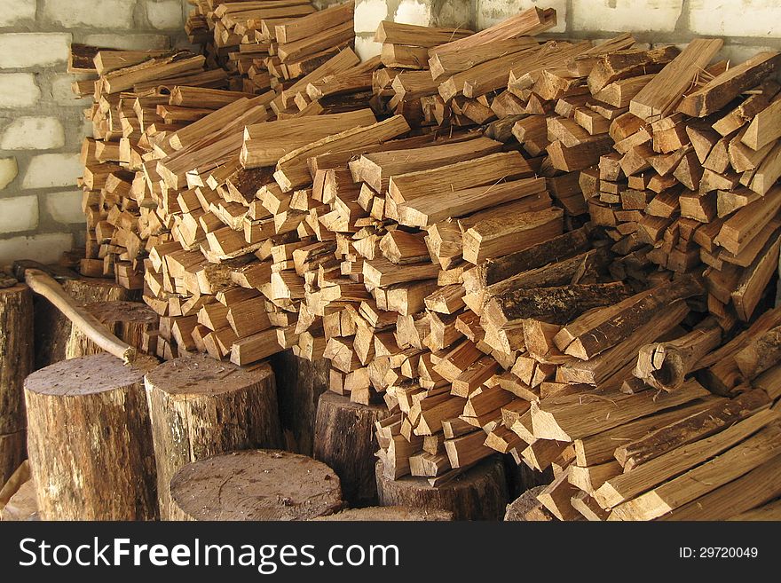 Pile of chopped firewood prepared for winter, stacked and organized in woodshed. Pile of chopped firewood prepared for winter, stacked and organized in woodshed.