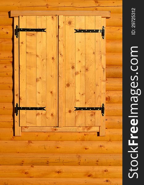 Closed window on wooden wall of a chalet