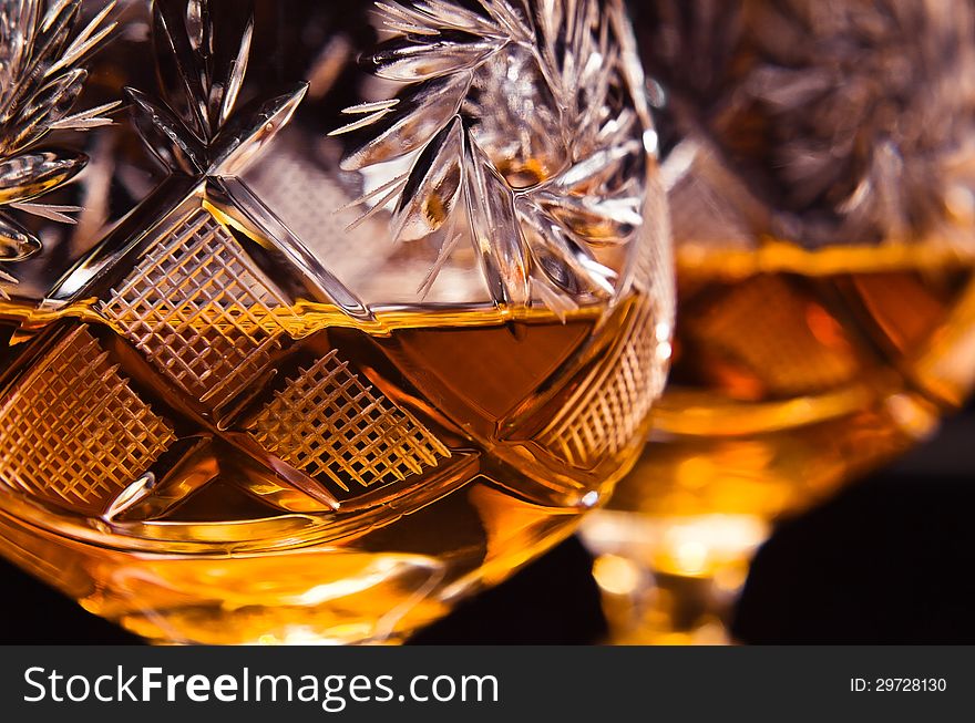 Shot of a cut crystal glass containing brandy.