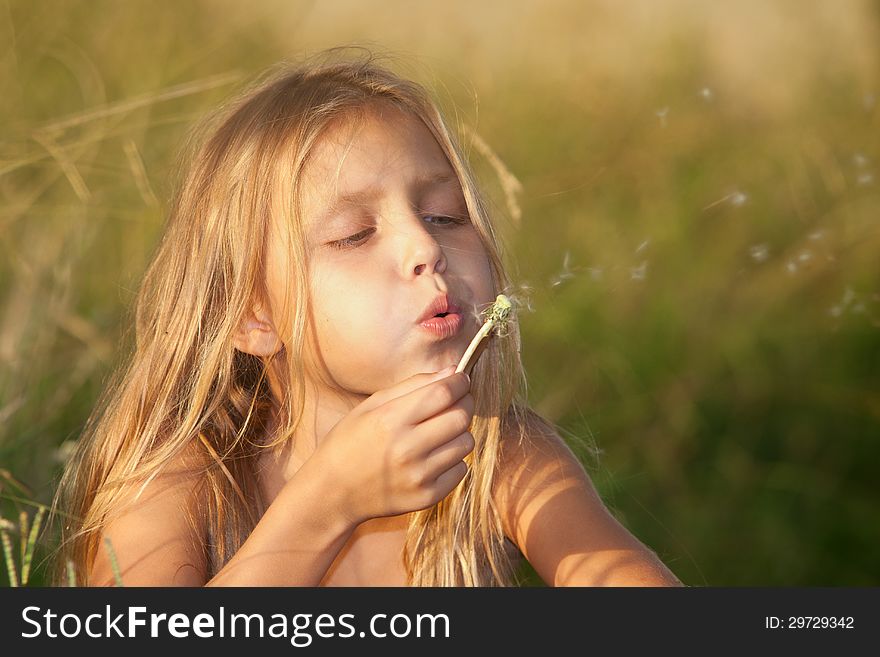 Portrait of a little girl with dandelion