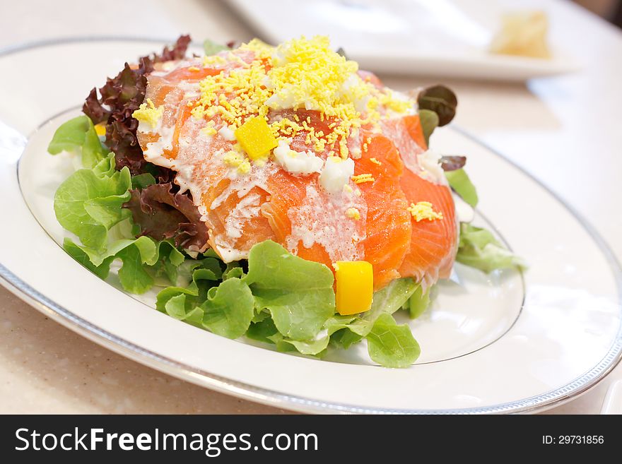 Image of Smoke salmon salad on white dish