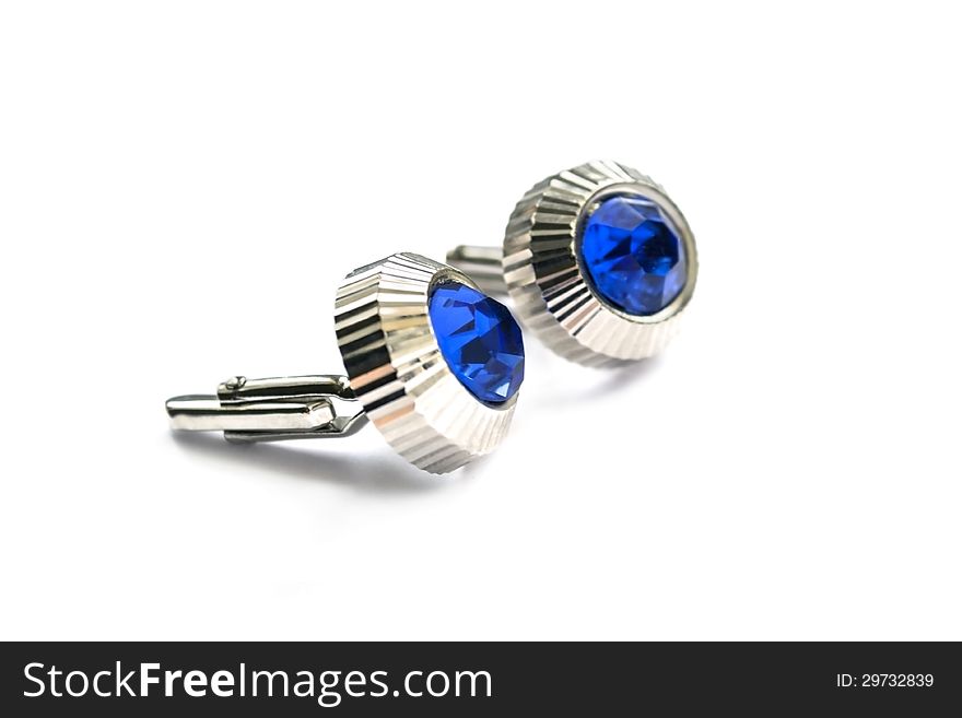 Cufflinks with blue gems on white background