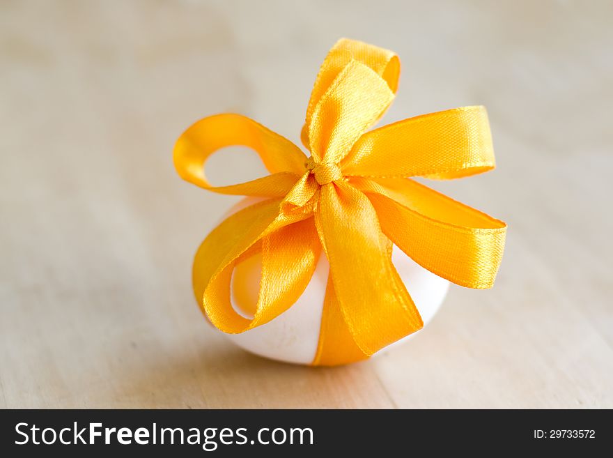 Easter egg, tied with a yellow ribbon