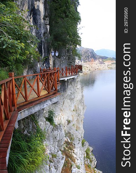 Artificial walk way in a rock by lake