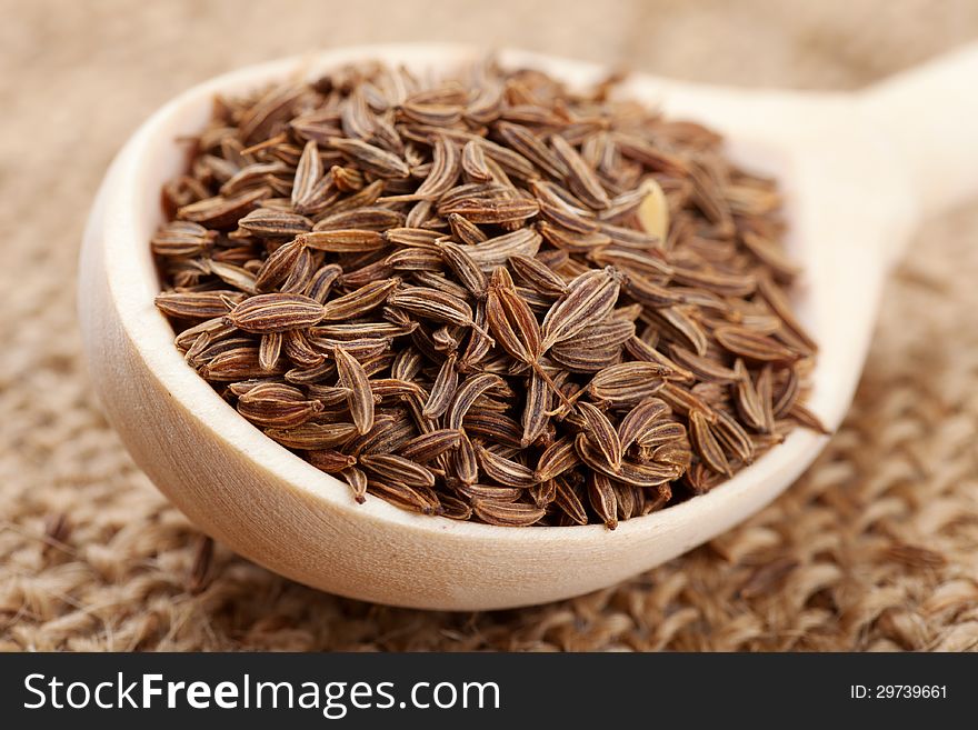 Cumin seeds in wooden spoon. Cumin seeds in wooden spoon