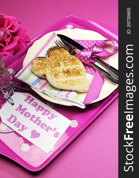 Happy Mothers Day breakfast tray with pink rose and heart shape toast on polka dot tray. Vertical. Happy Mothers Day breakfast tray with pink rose and heart shape toast on polka dot tray. Vertical.