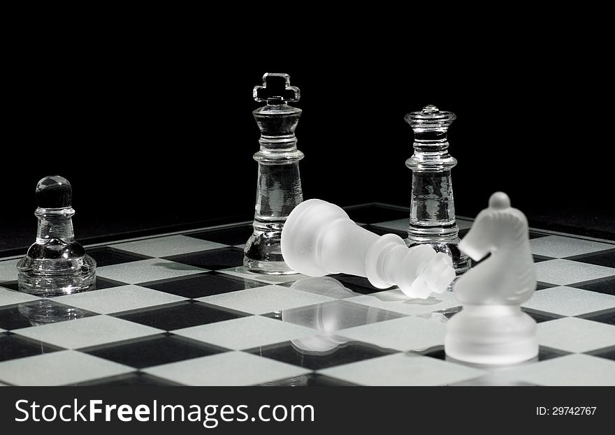 Final pieces in a chess game – Checkmate. Selective focus on down king.