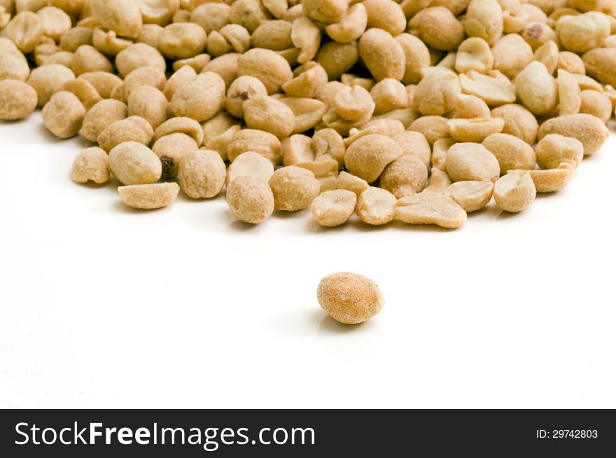 Selective focus on the individual peanut in the foreground a group of peanuts. Selective focus on the individual peanut in the foreground a group of peanuts