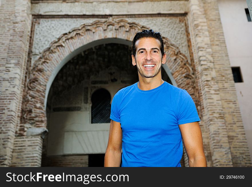 Portrait of an attractive smiling man in urban background. Portrait of an attractive smiling man in urban background