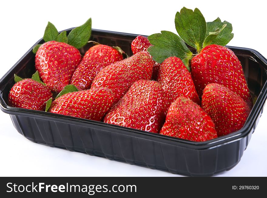 Juicy bright natural strawberry in plastic packaging