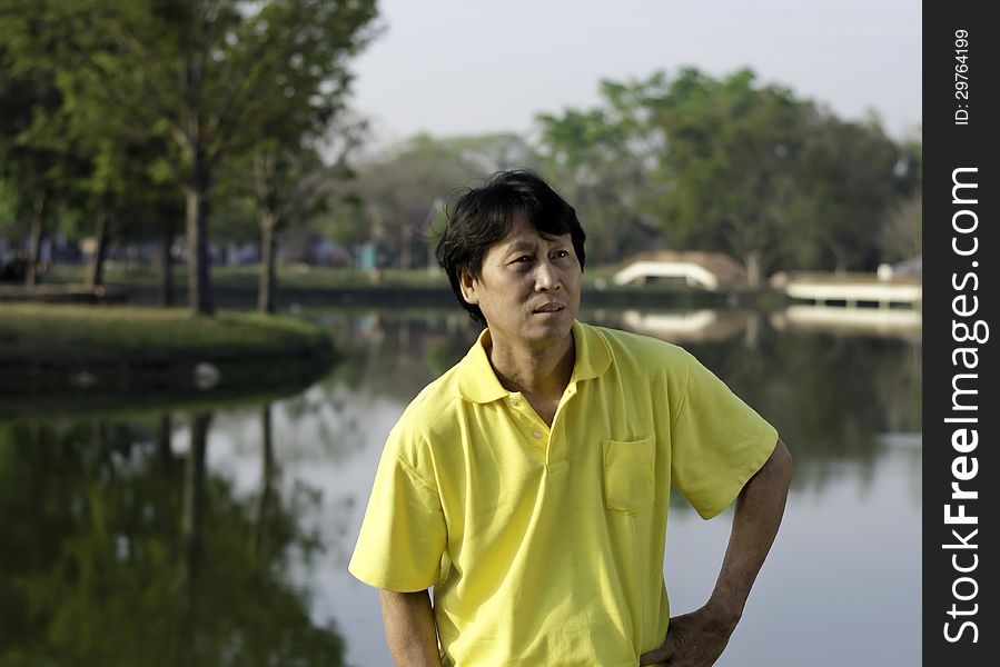 A portrait of a senior south asian man by lake