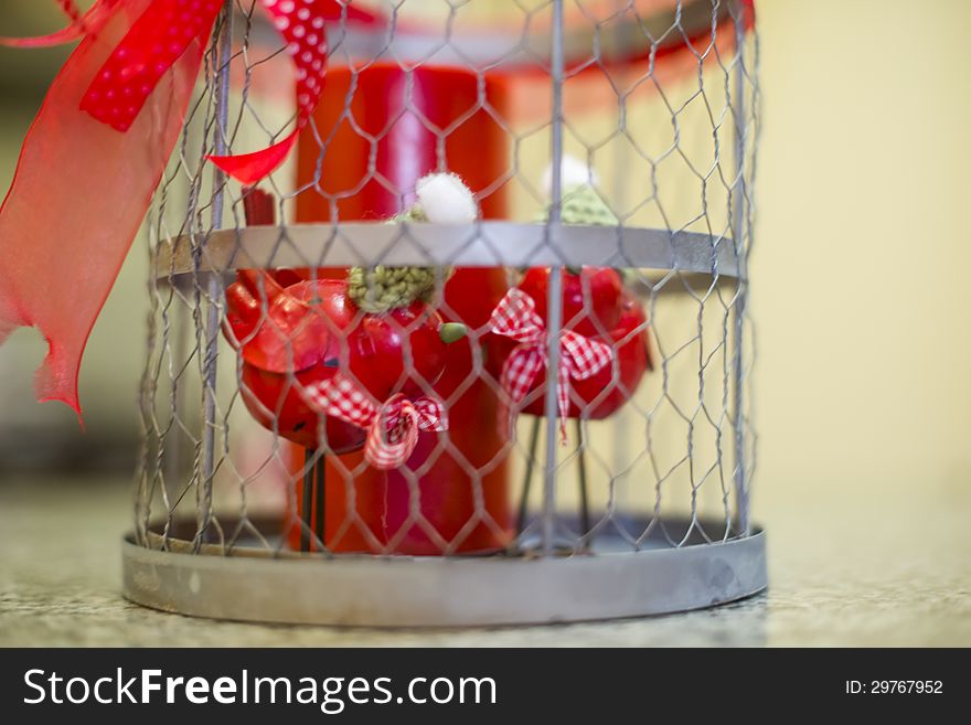 Beautiful ornament for Easter with red small birds and candle in a cage. Beautiful ornament for Easter with red small birds and candle in a cage