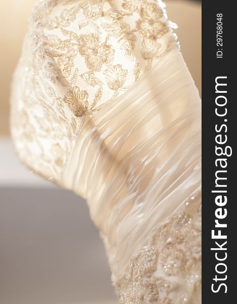 Beautiful luxury white wedding dress with beautiful details in warm light. Beautiful luxury white wedding dress with beautiful details in warm light
