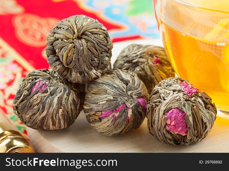 Chinese green tea balls with flowers, tea cup