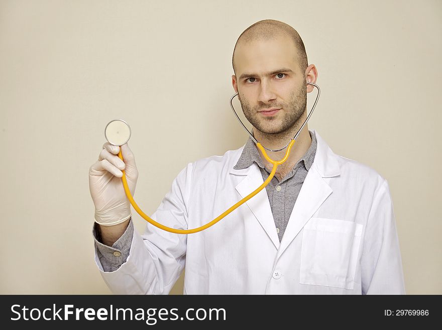 Portrait of a doctor of stethoscope isolated on light background