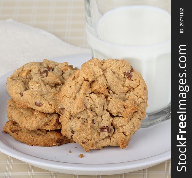 Peanut butter cookies and glass of milk on a plate. Peanut butter cookies and glass of milk on a plate