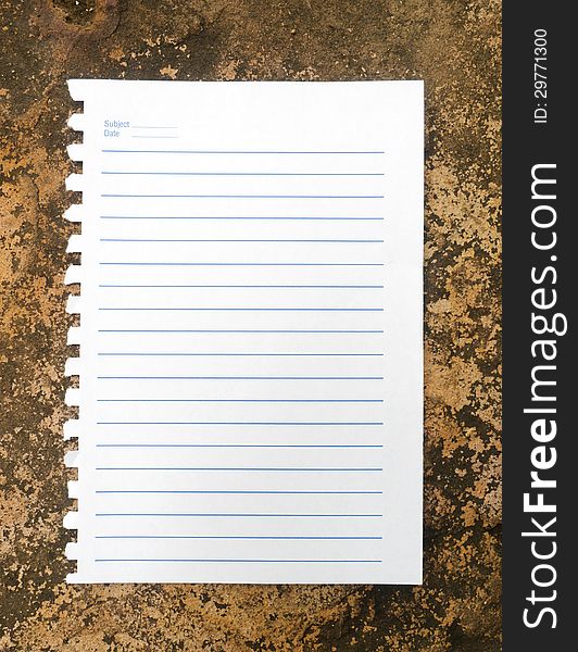 Notebook paper on rock background.