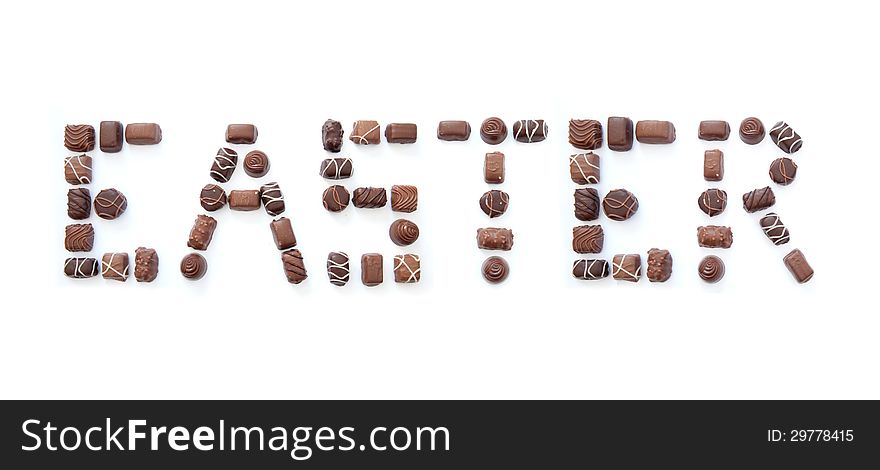 The word easter formed using chocolates over a white background. The word easter formed using chocolates over a white background