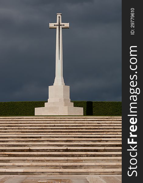 Large marble cross with a sword decoration at a war grave cemetery. Large marble cross with a sword decoration at a war grave cemetery