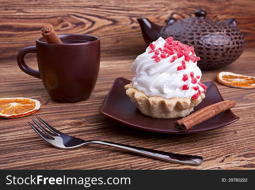 Cake and tea with cinnamon on a wooden background. selective focus