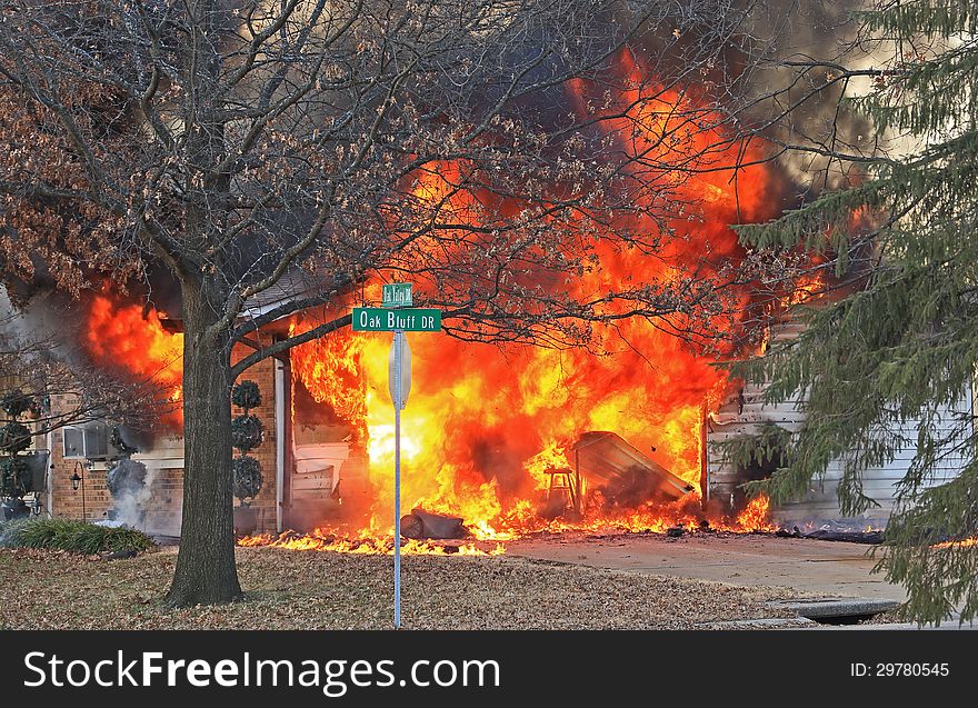 House fire with the garage fully engulfed in flames. House fire with the garage fully engulfed in flames