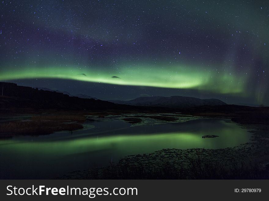 Northern Lights Above A Lagoon In Iceland