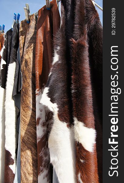 Photo of cow hide fur rugs and mats.