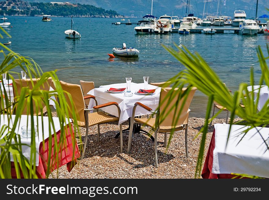 Restaurant tables on the Mediterranean Sea in the summer. Restaurant tables on the Mediterranean Sea in the summer