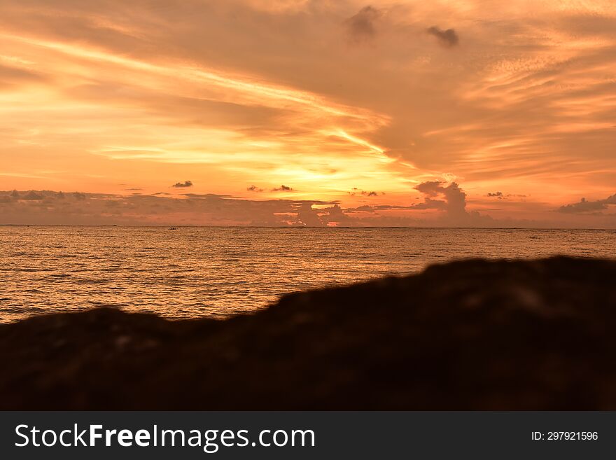 Sunset With Warm Cloudy Weather on The Bali Coast Towards The Indian Ocean