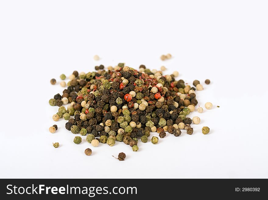 Multi color pepper seeds isolated over a white background