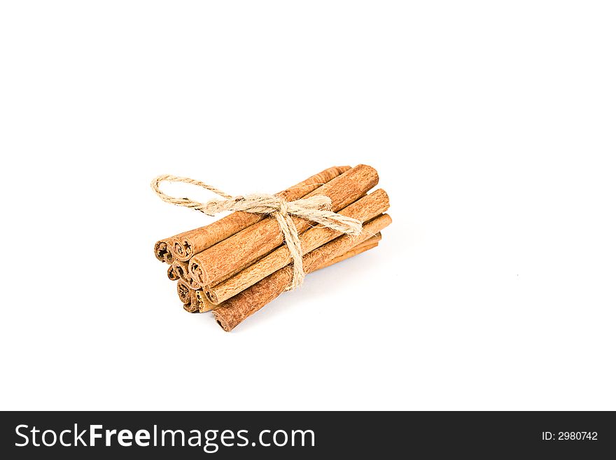 Cinnamon spicy sticks close-up isolated over a white background