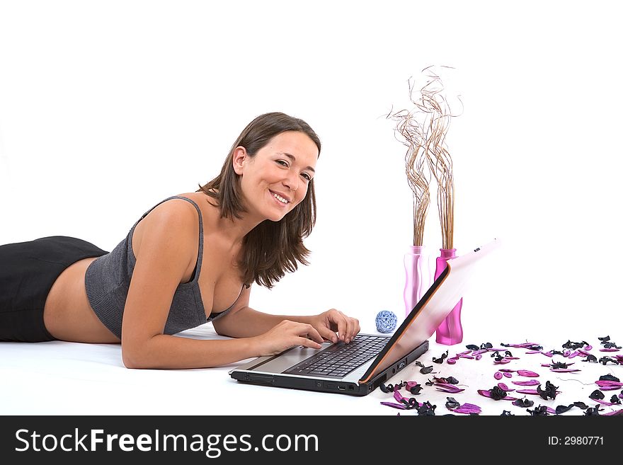 Pretty young woman enjoying with laptop and smiling on white background. Pretty young woman enjoying with laptop and smiling on white background