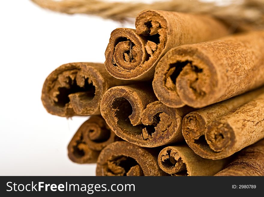 Cinnamon spicy sticks close-up isolated over a white background