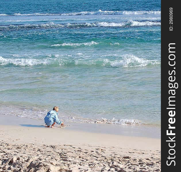 A small boy playing at the beach