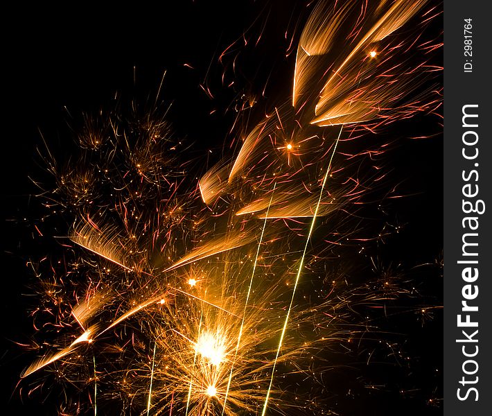 Yellow and red fireworks on night sky