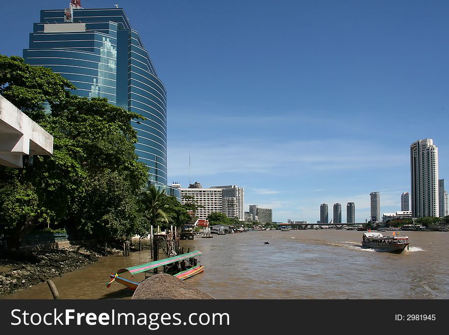 Modern offices and hotels line the Chao Praya River in Bangkok