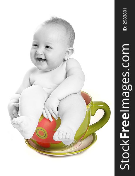 Baby in a big tea cup half colored and half black and white. Baby in a big tea cup half colored and half black and white.