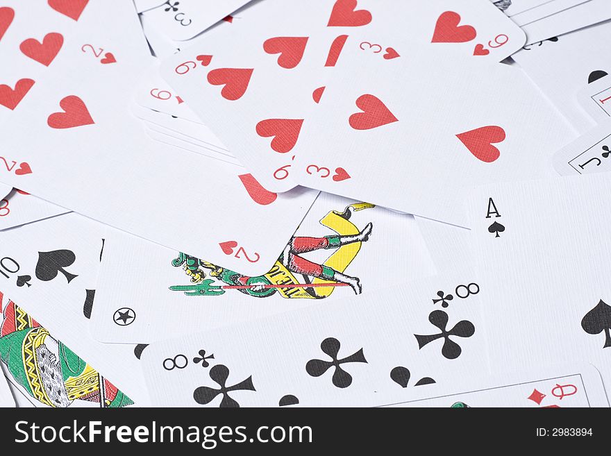 Set of playing cards are scattered on a table