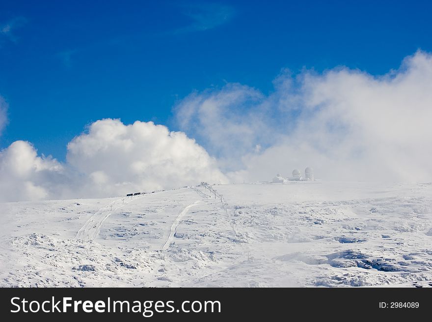 Snowy mountain top with blue sky. Snowy mountain top with blue sky