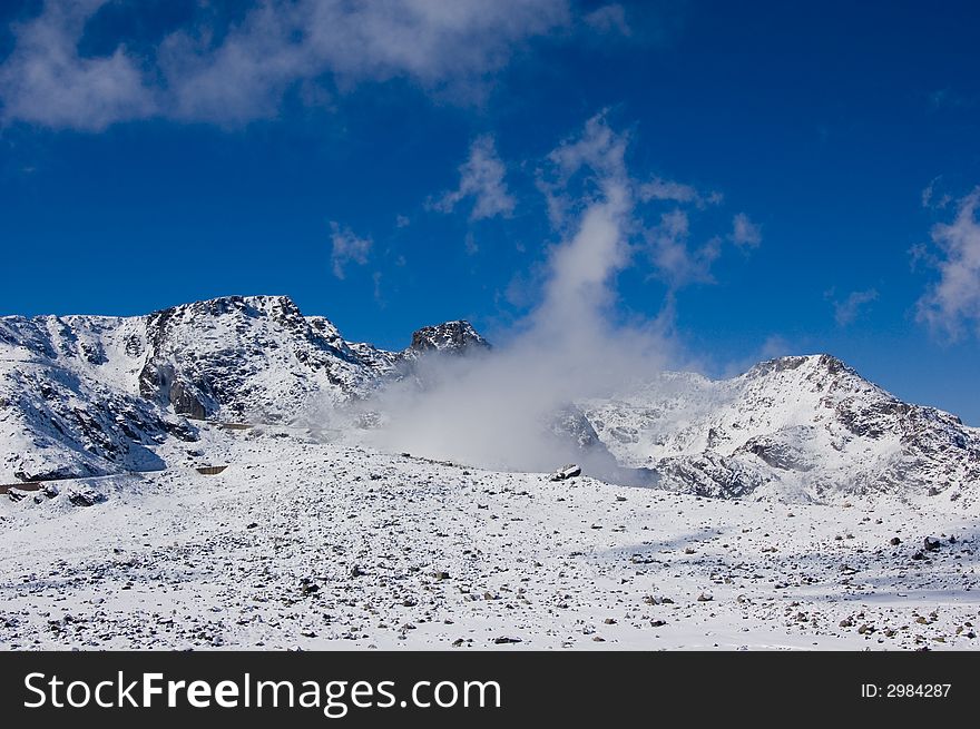 Snowy mountain top with blue sky