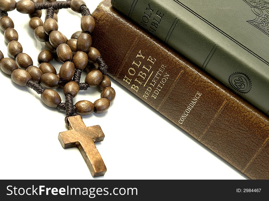 Bible and rosary on a white background. Bible and rosary on a white background