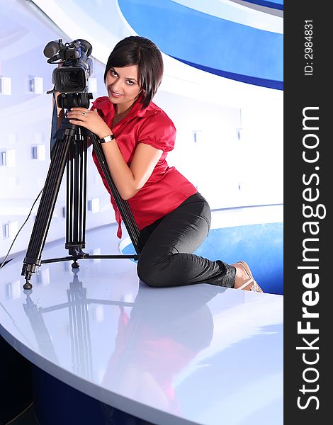 Young woman reporter posing like a photo model in TV studio. Young woman reporter posing like a photo model in TV studio