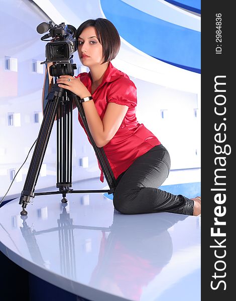 Young woman reporter posing like a photo model in TV studio. Young woman reporter posing like a photo model in TV studio