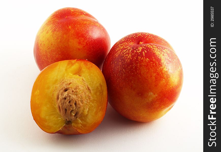 Three nectarines isolated on white background