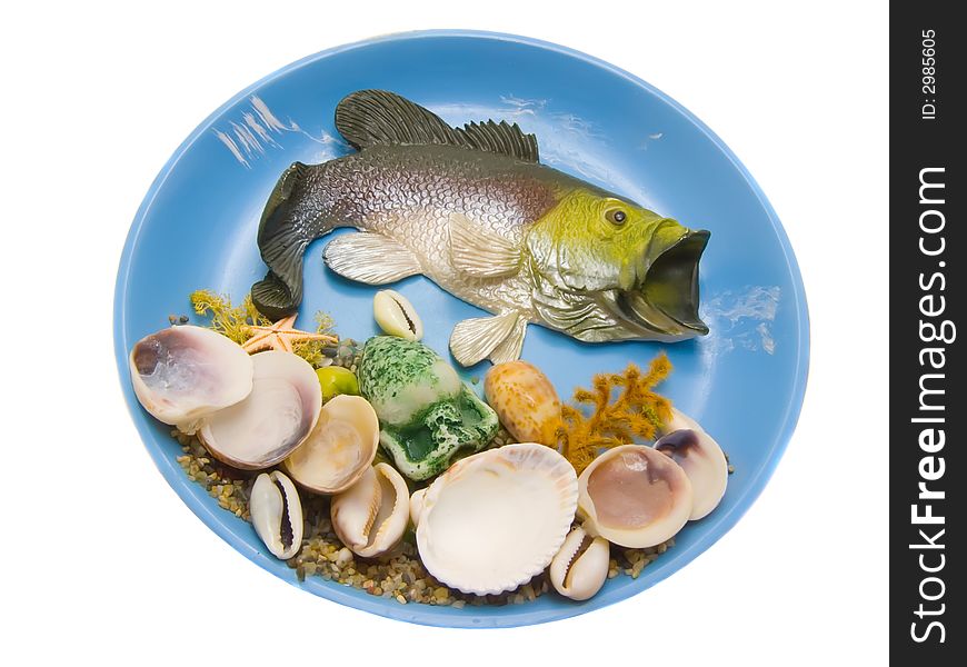 An isolated photo of a fish and shells on the plate. An isolated photo of a fish and shells on the plate