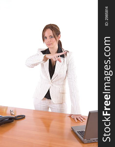 Beautiful young female executive pointing with her finger (dismissing an employee, for instance) - over a white background. Beautiful young female executive pointing with her finger (dismissing an employee, for instance) - over a white background