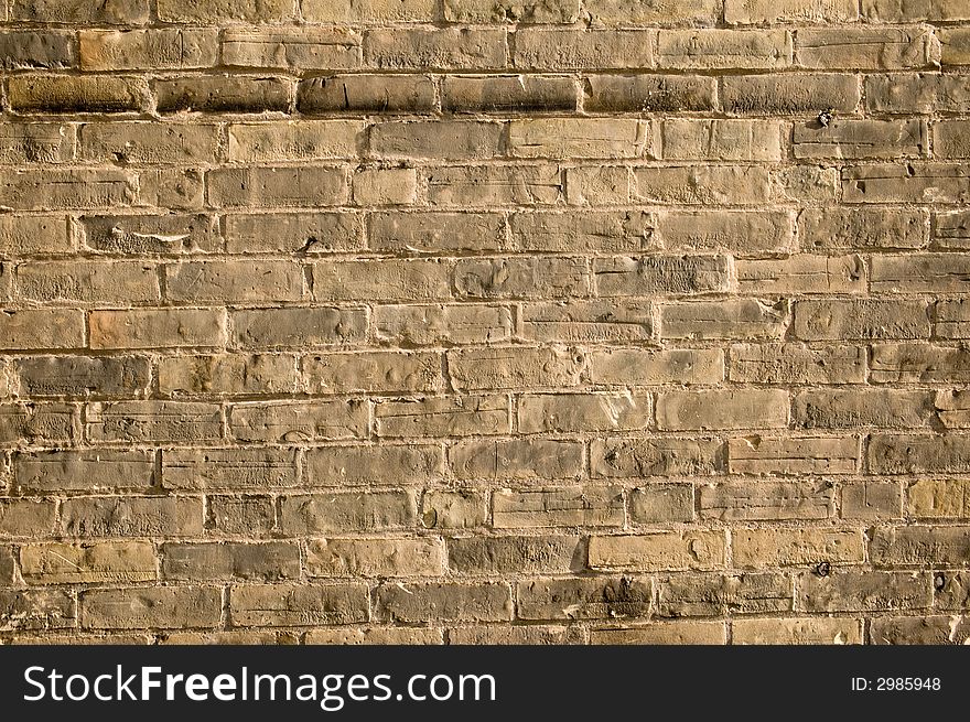 Grungy rustic old yellow brick wall with scratches and weathering. Grungy rustic old yellow brick wall with scratches and weathering