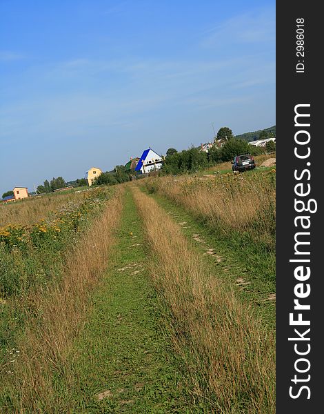 Field background: green field, road and houses.