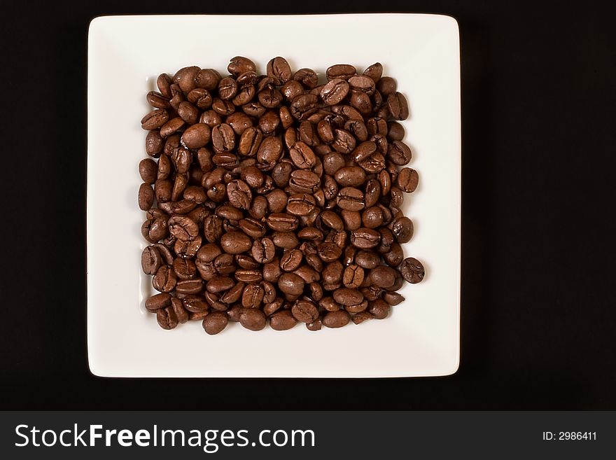 Coffee beans on the while plate